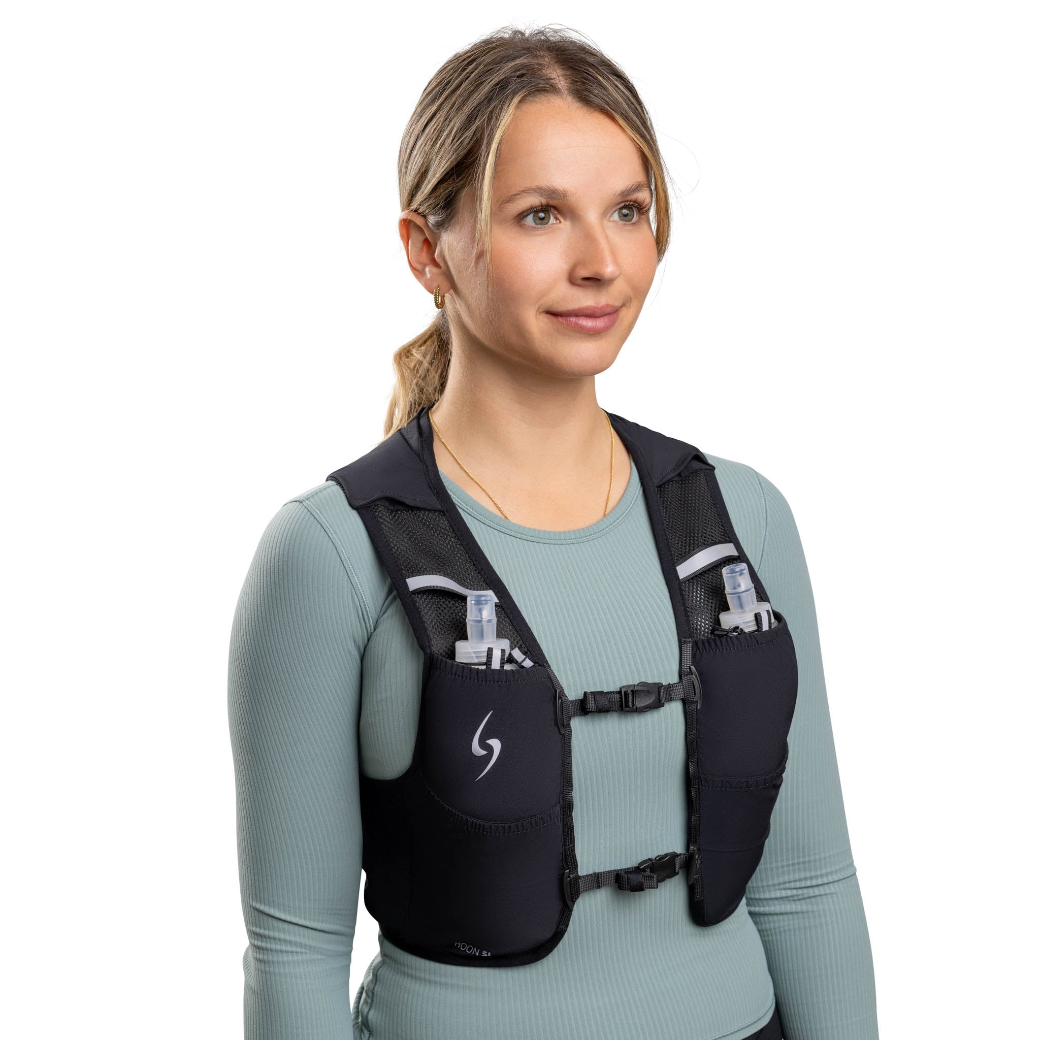 Woman wearing a black hydration vest on a white background